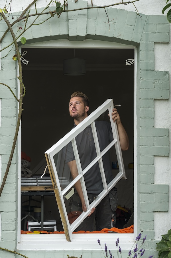 a craftsman fitting a new window